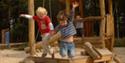 Children jumping into Sand At Haldon Forest Park
